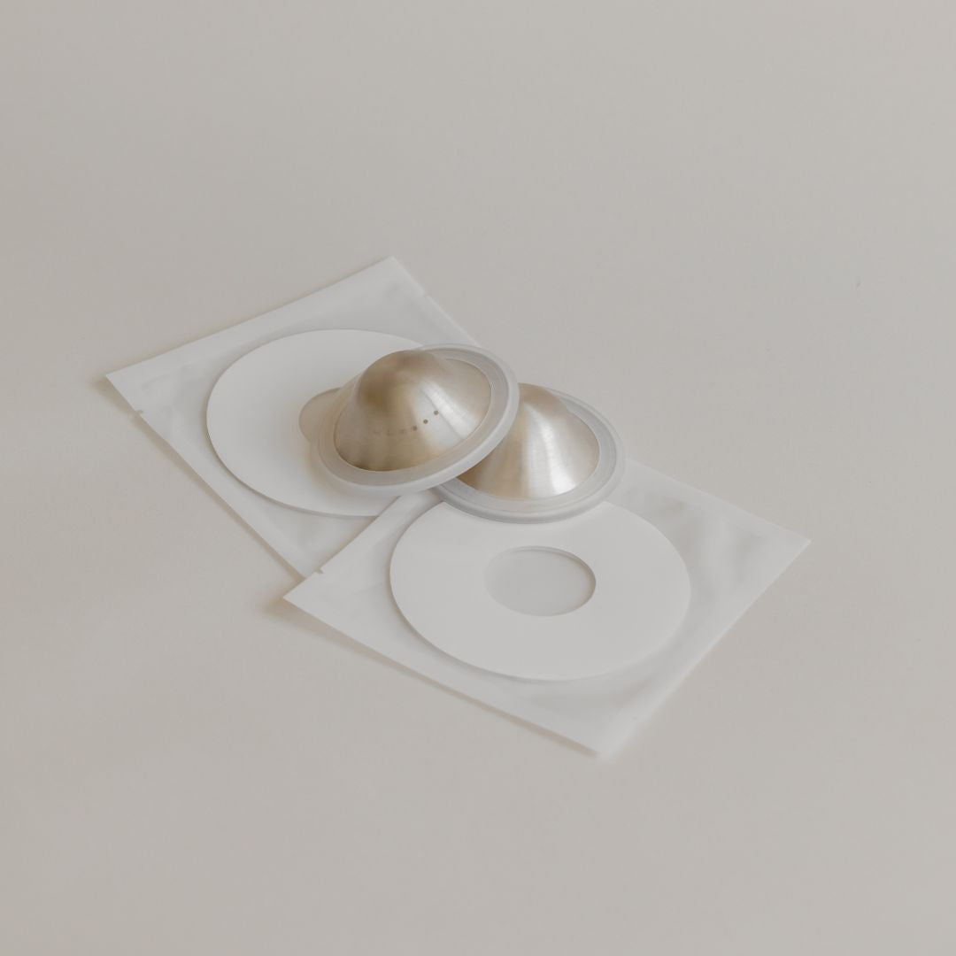 Two Mammae silver nipple care bundles in sealed white packaging, arranged overlapping each other on a light beige background.