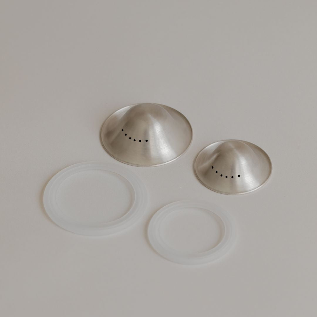 Two Mammae silver nipple care bundles with clear silicone lids designed for breastfeeding mothers, arranged on a light background.