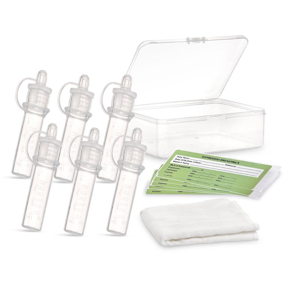 A clear container with a set of Haakaa Pre-sterilised Silicone Colostrum Collector | 6pk bottles and a tissue.