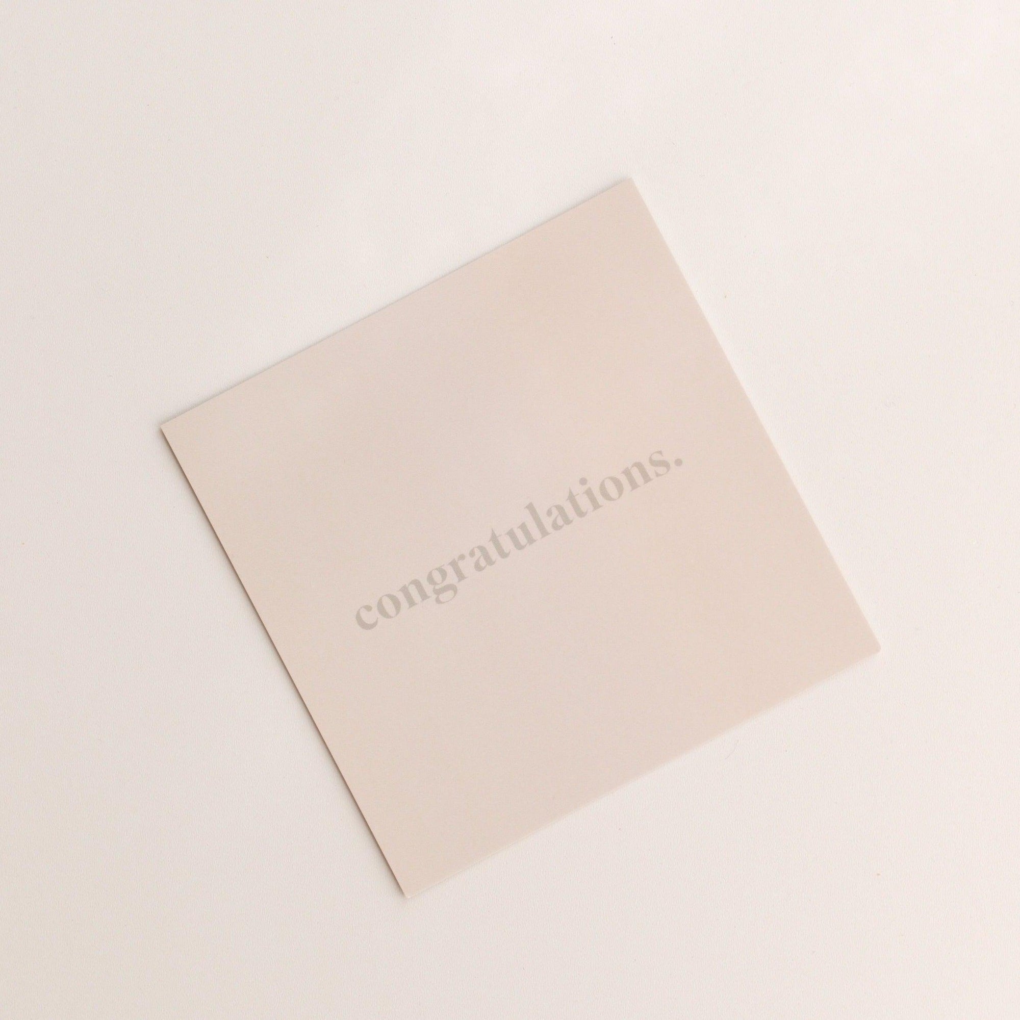 A square "congratulations | gift card" by biglittlethings. on a light surface, featuring the word "congratulations." printed in lowercase.