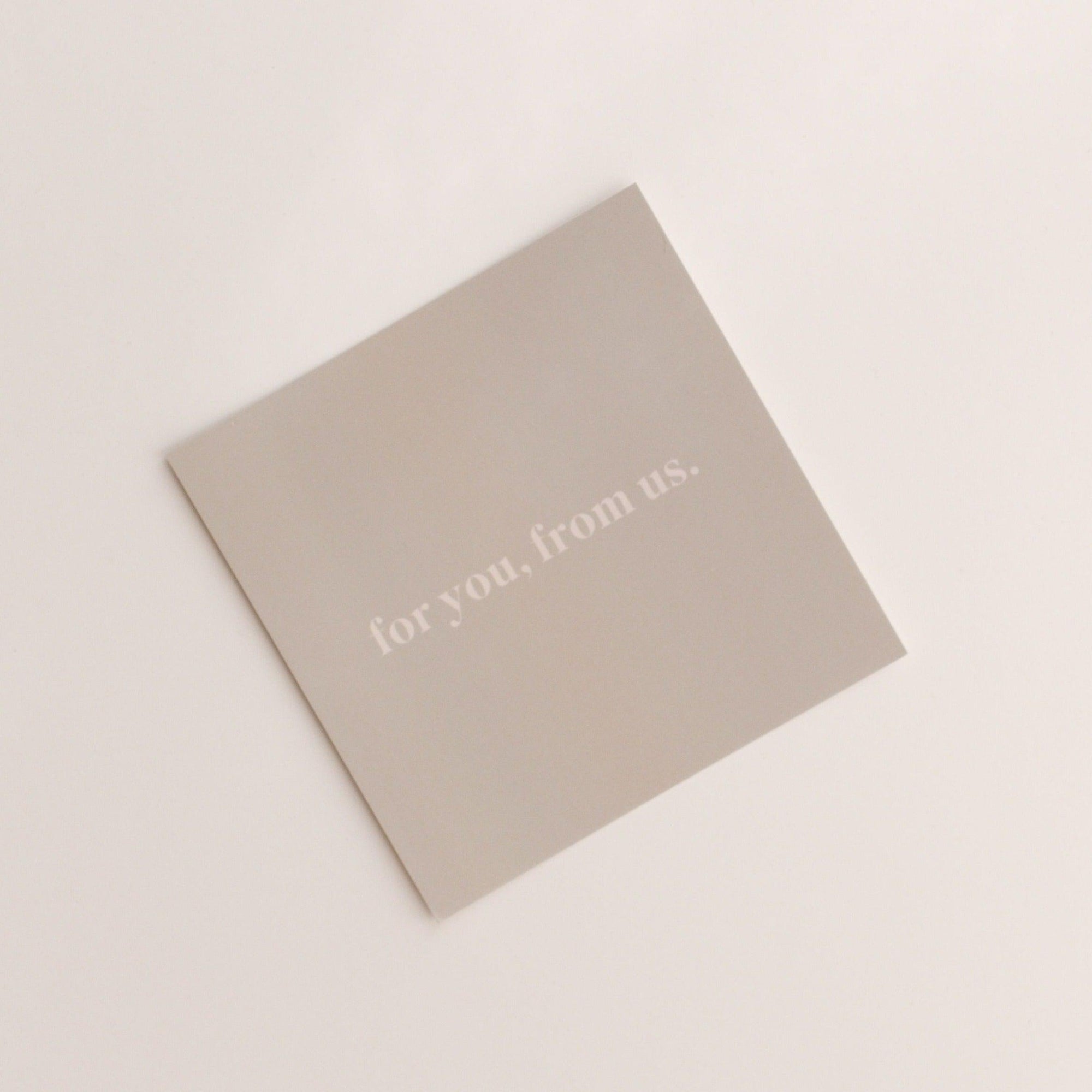 A square "for you, from us | gift card" by biglittlethings., featuring the text "for you, from us." printed in white on a beige background.