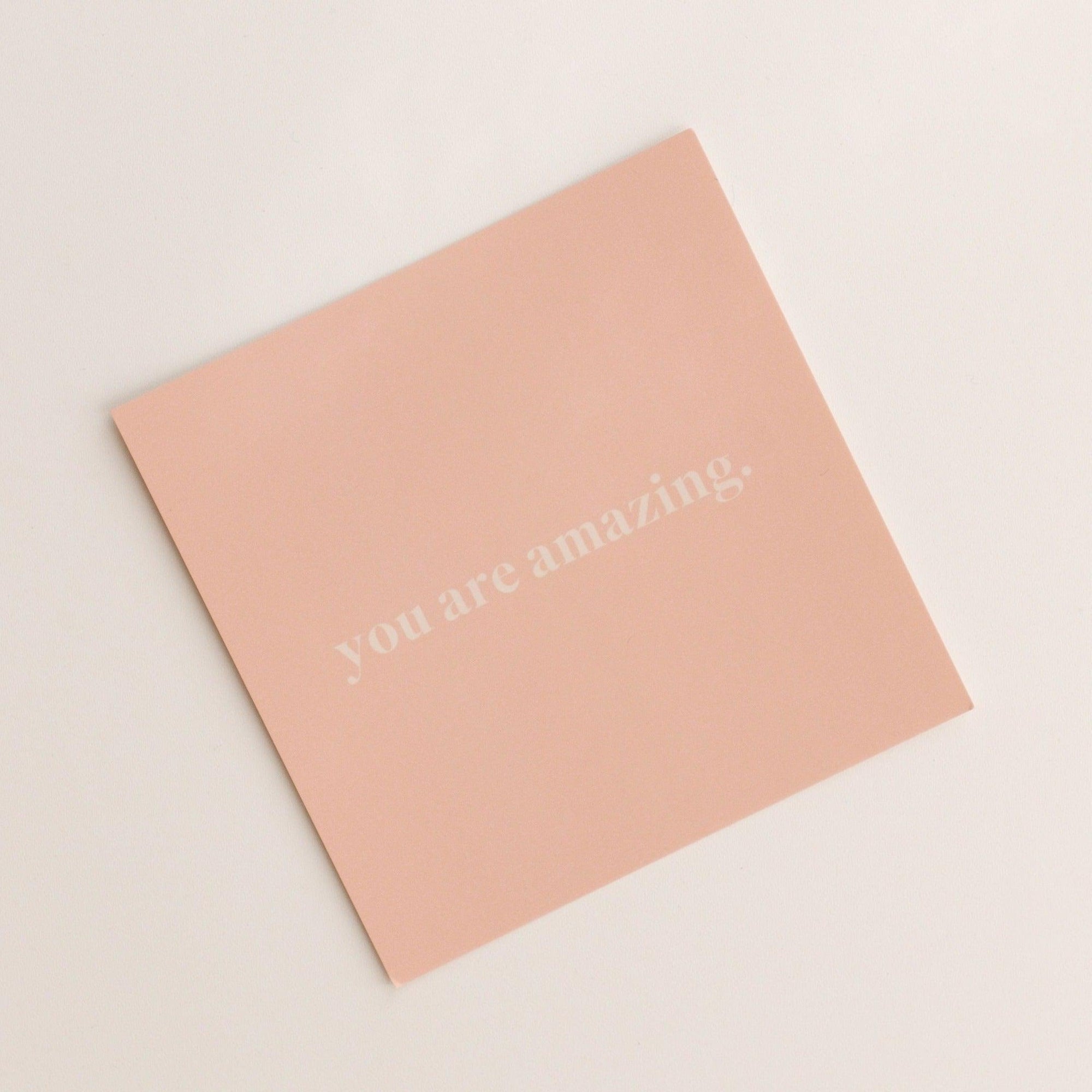 The "you are amazing | gift card" by biglittlethings. features a pink card with white text that reads "you are amazing" centered on a plain off-white background.