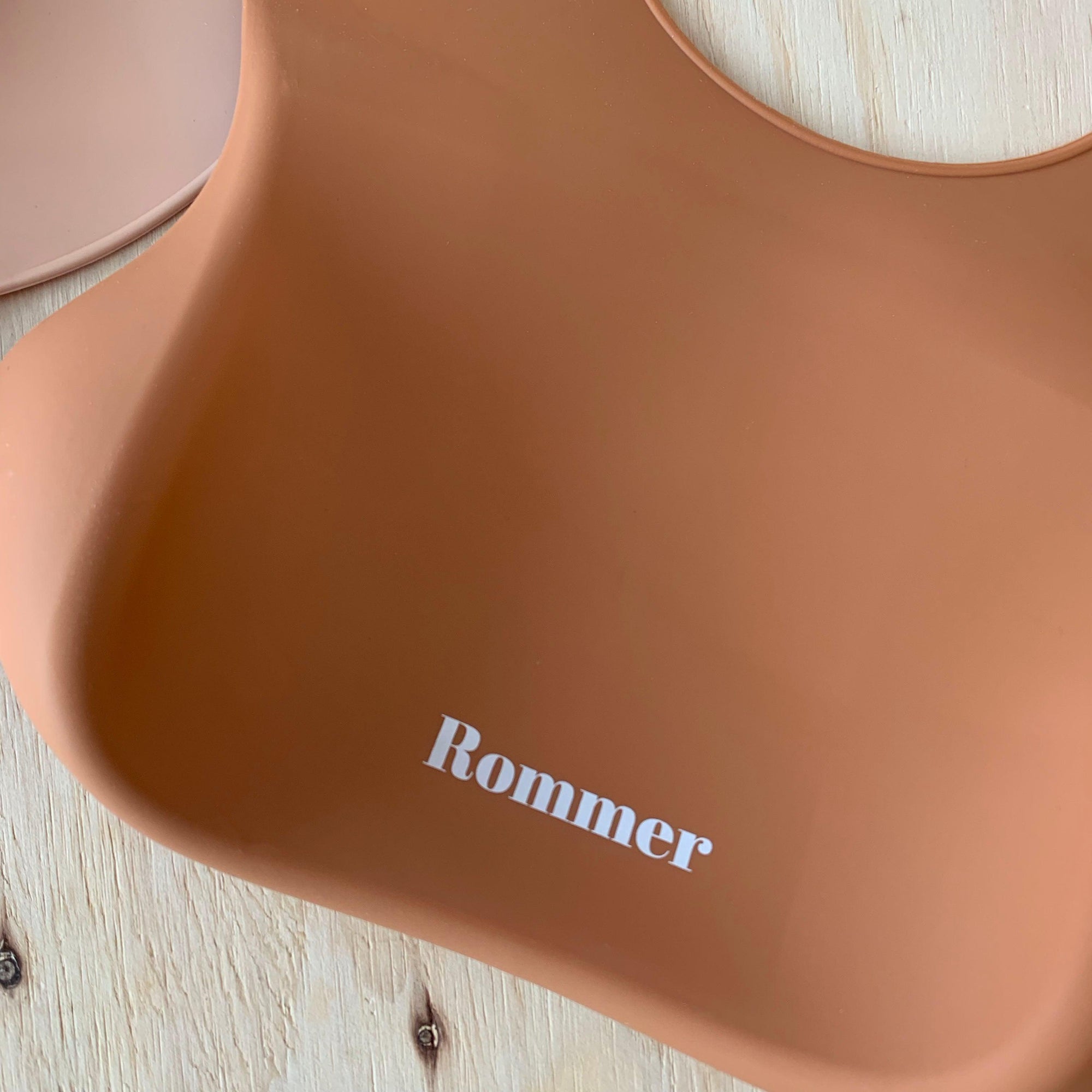 Rommer bibs are made from the softest silicone. They are both lightweight and durable. Rommer has updated the bib design to feature the reinforced button holes making them more resistant to tears.