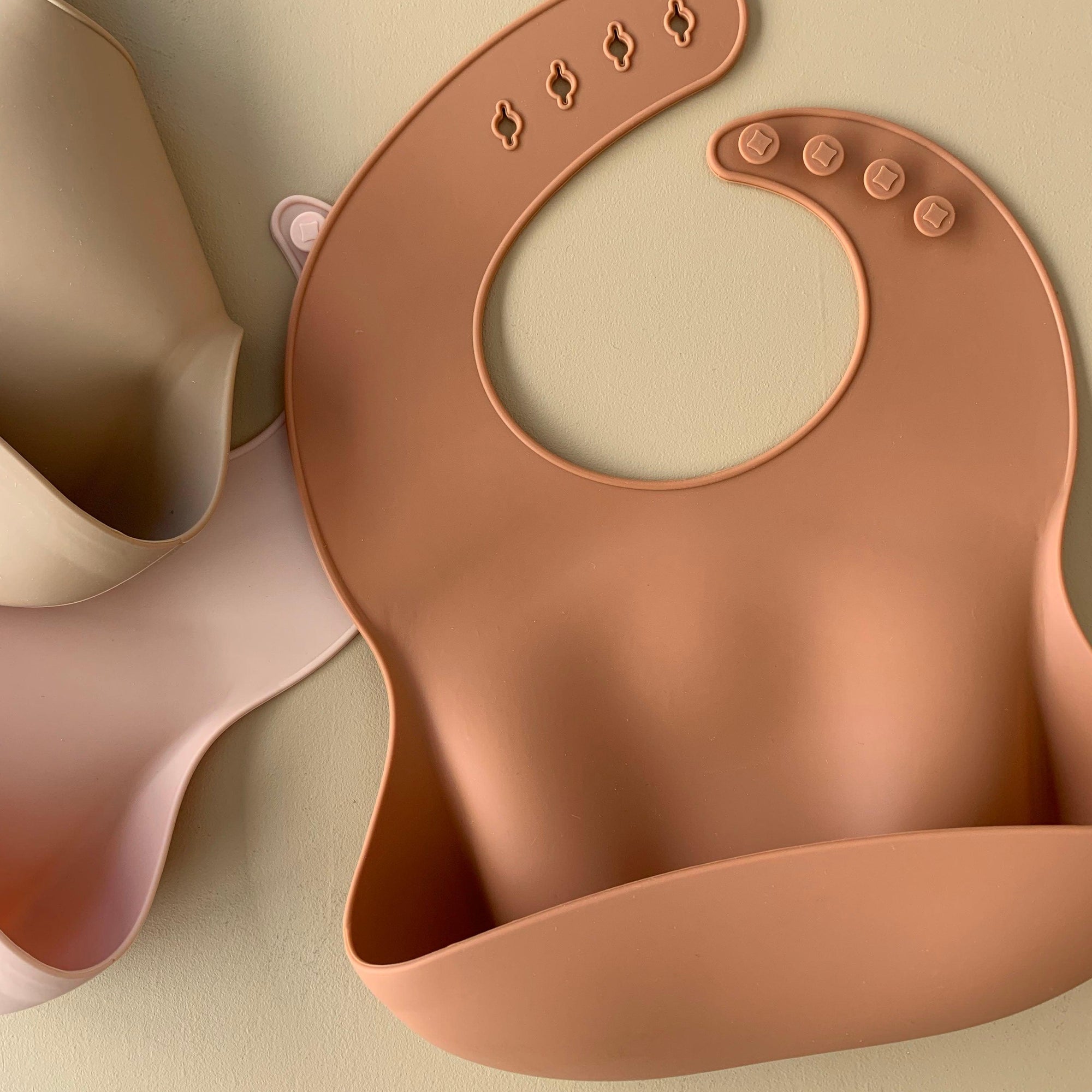 Rommer bibs are made from the softest silicone. They are both lightweight and durable. Rommer has updated the bib design to feature the reinforced button holes making them more resistant to tears.