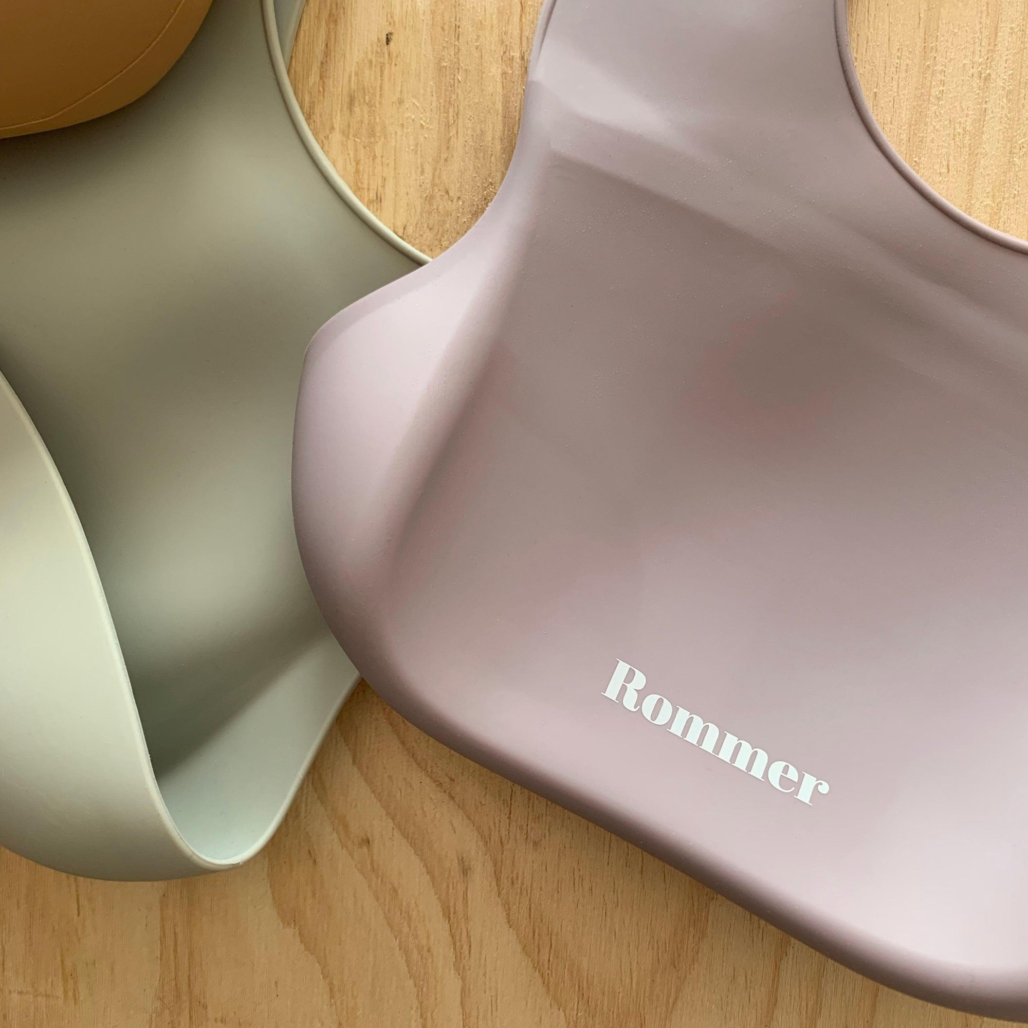 Rommer bibs are made from the softest silicone. They are both lightweight and durable. Rommer has updated the bib design to feature the reinforced button holes making them more resistant to tears.