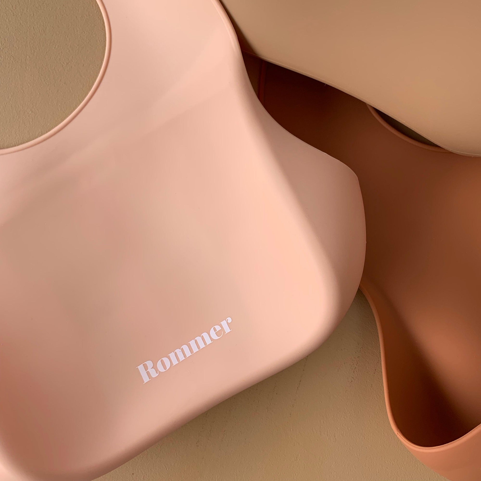 Rommer bibs are made from the softest silicone. They are both lightweight and durable. Rommer has updated the bib design to feature the reinforced button holes making them more resistant to tears.