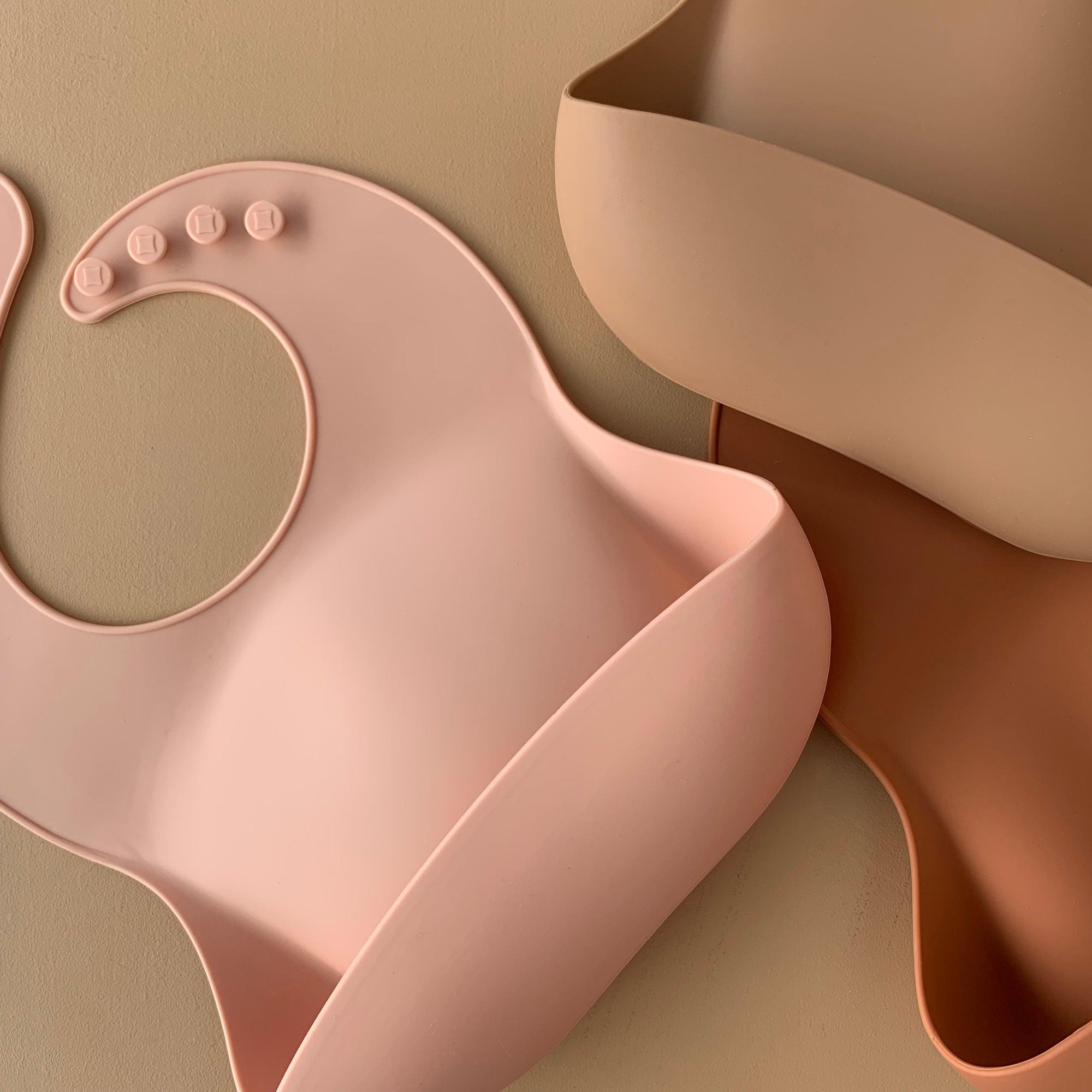 Rommer bibs are made from the softest silicone. They are both lightweight and durable. Rommer has updated the bib design to feature the reinforced button holes making them more resistant to tears.
