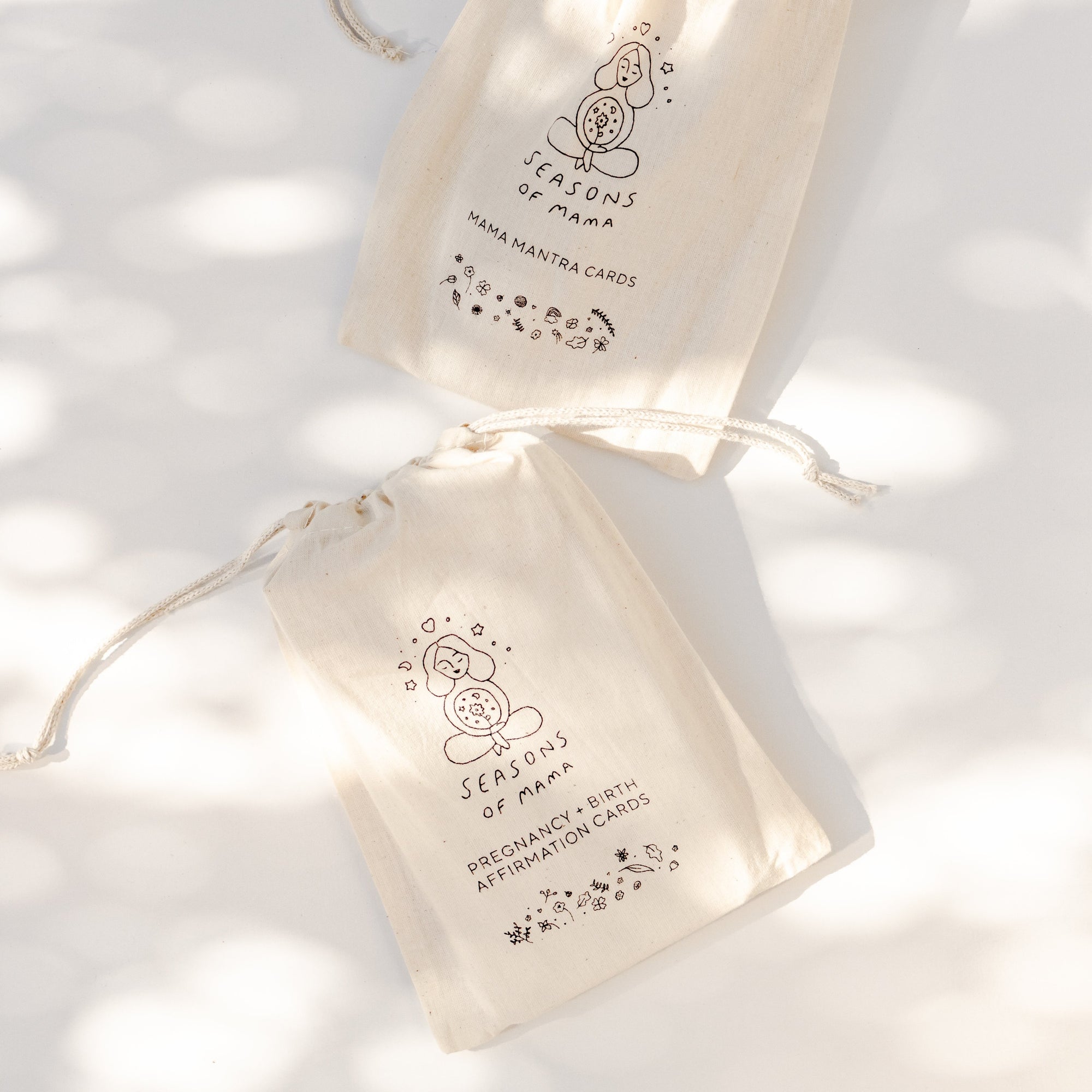 Two Seasons of Mama branded calico bag on a white surface.