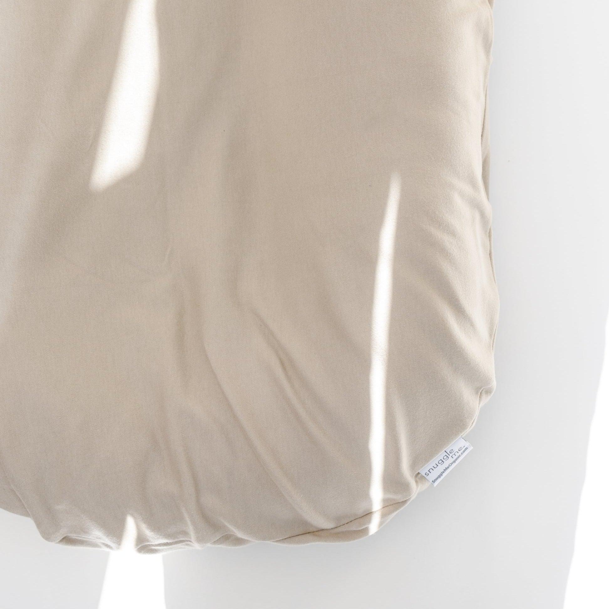 Snuggle Me Lounger Cover in the shade birch on a snuggle me lounger on a white surface.