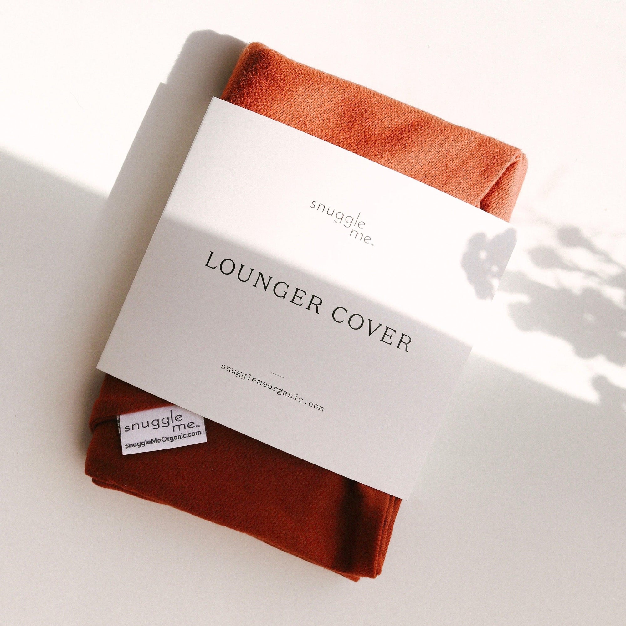 The Snuggle Me Lounger Cover in the shade Gingerbread on a white surface.