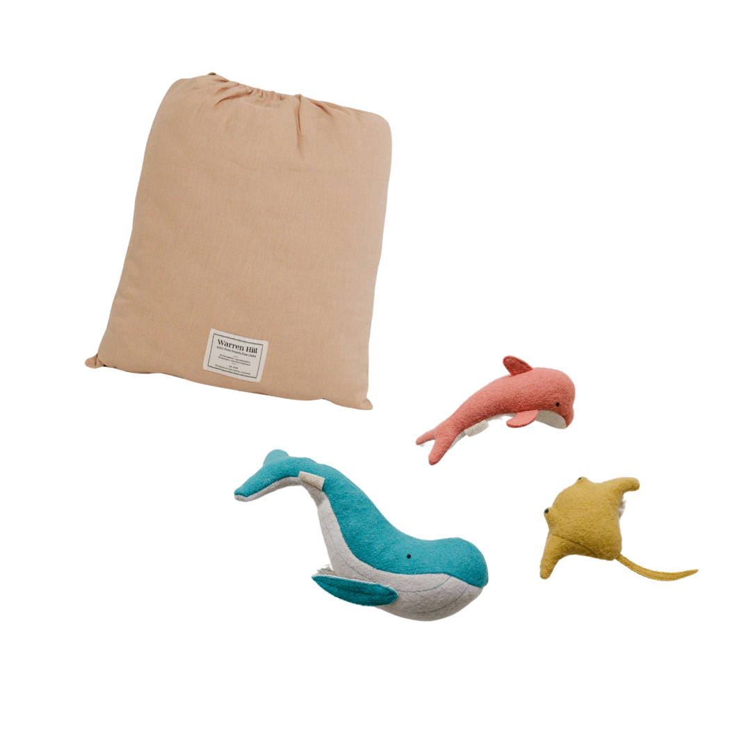 A playful play time gift set featuring a bag filled with stuffed animals, including an adorable dolphin and a majestic whale. The perfect companion for sparking creativity in children's playtime. (Brand Name: biglittlethings)