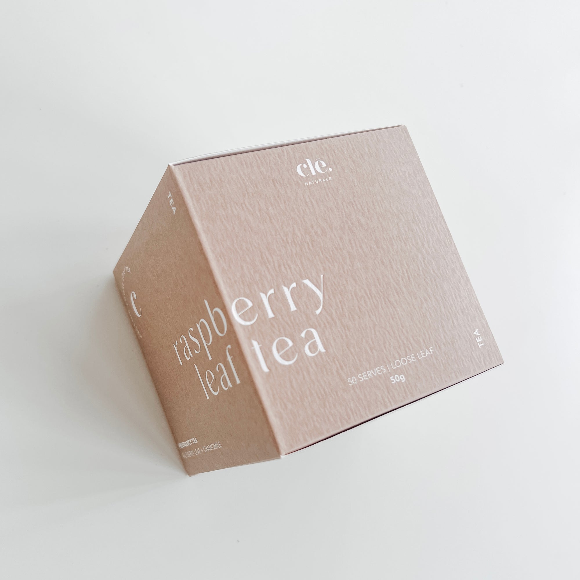 A pink cardboard box labeled "Clē Naturals certified organic raspberry leaf tea" with 40 servings, 50g weight indication, on a white background.