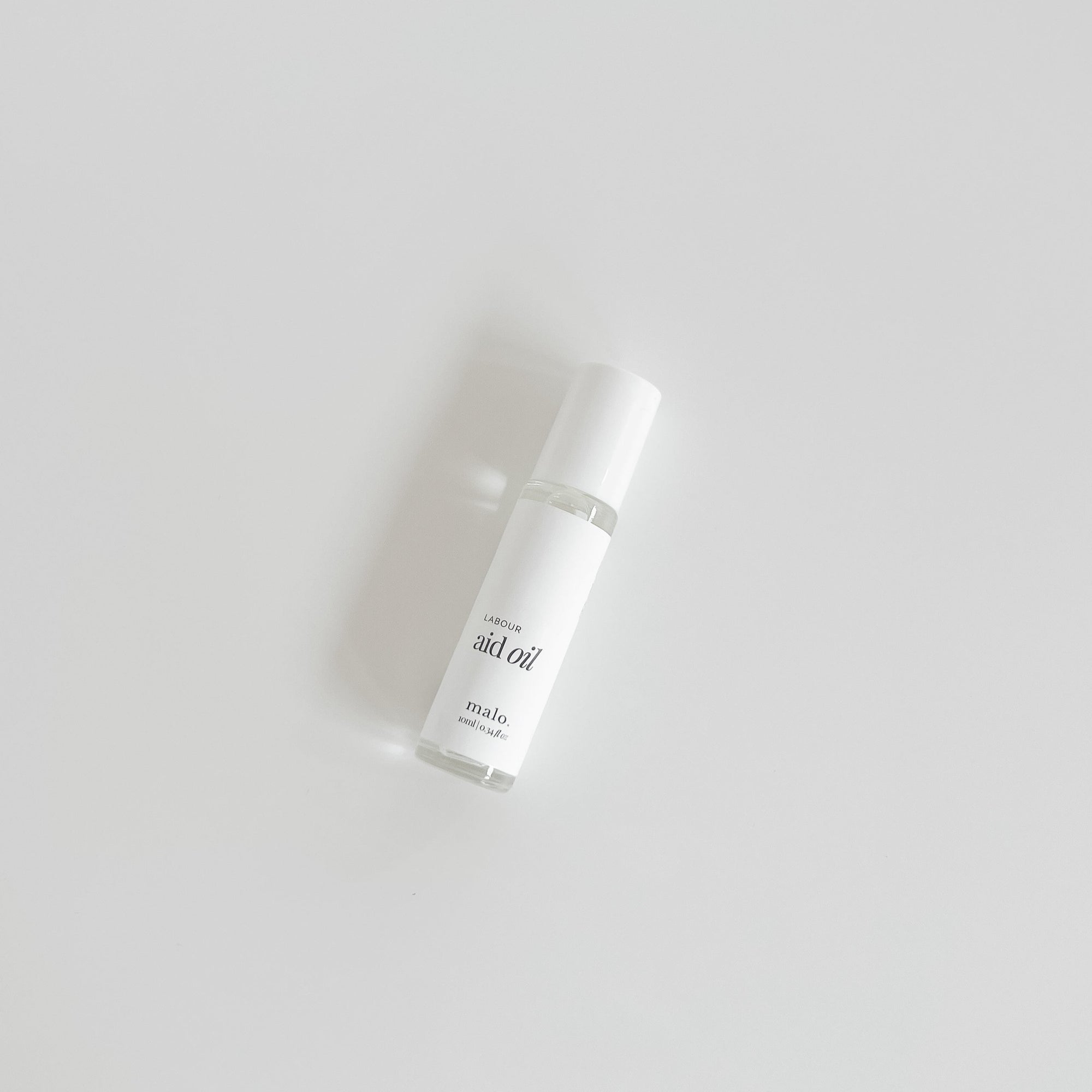 A bottle of Malo The Label skincare product containing Coconut Oil, placed on a plain white background.