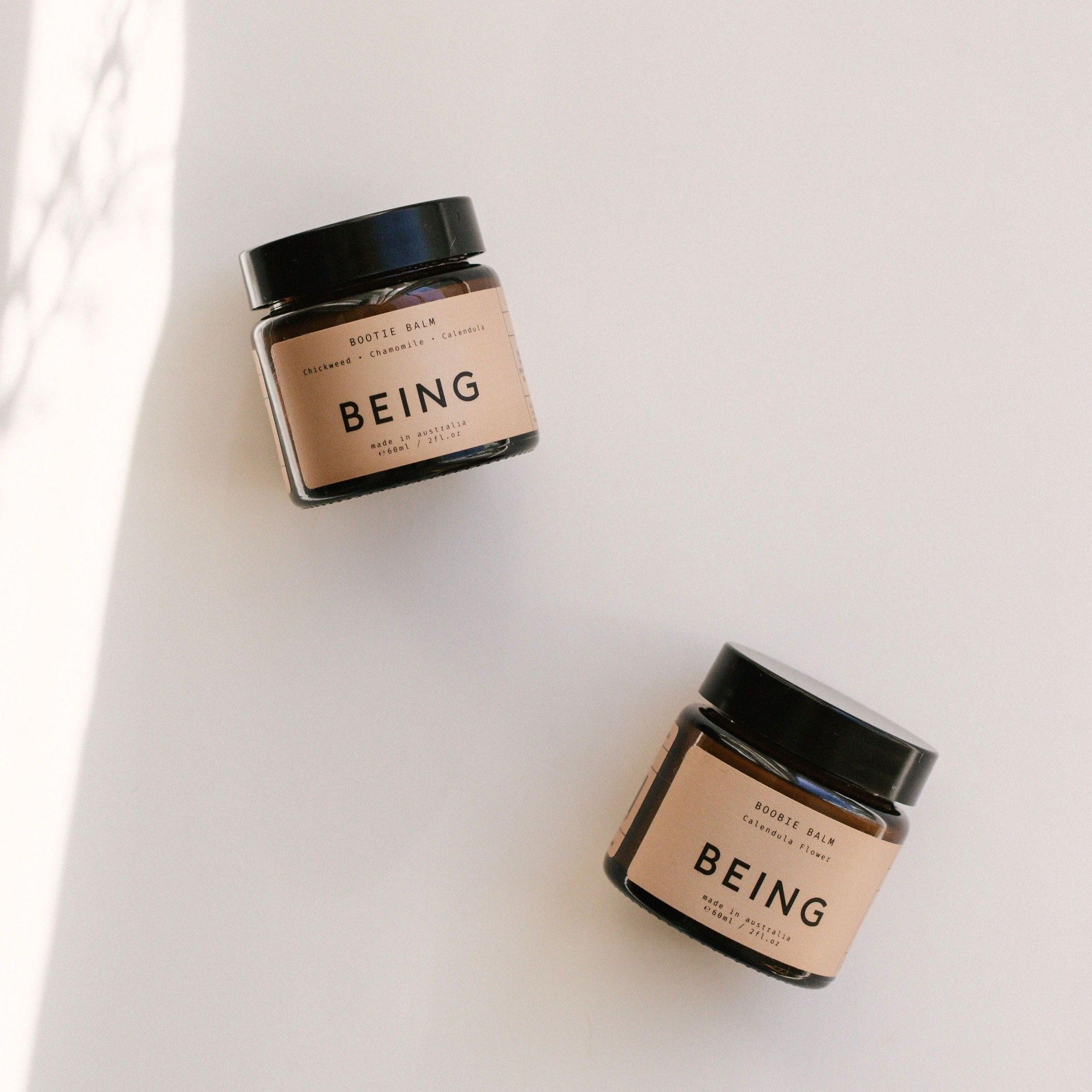 Two jars of the Being Skincare balm duo set.