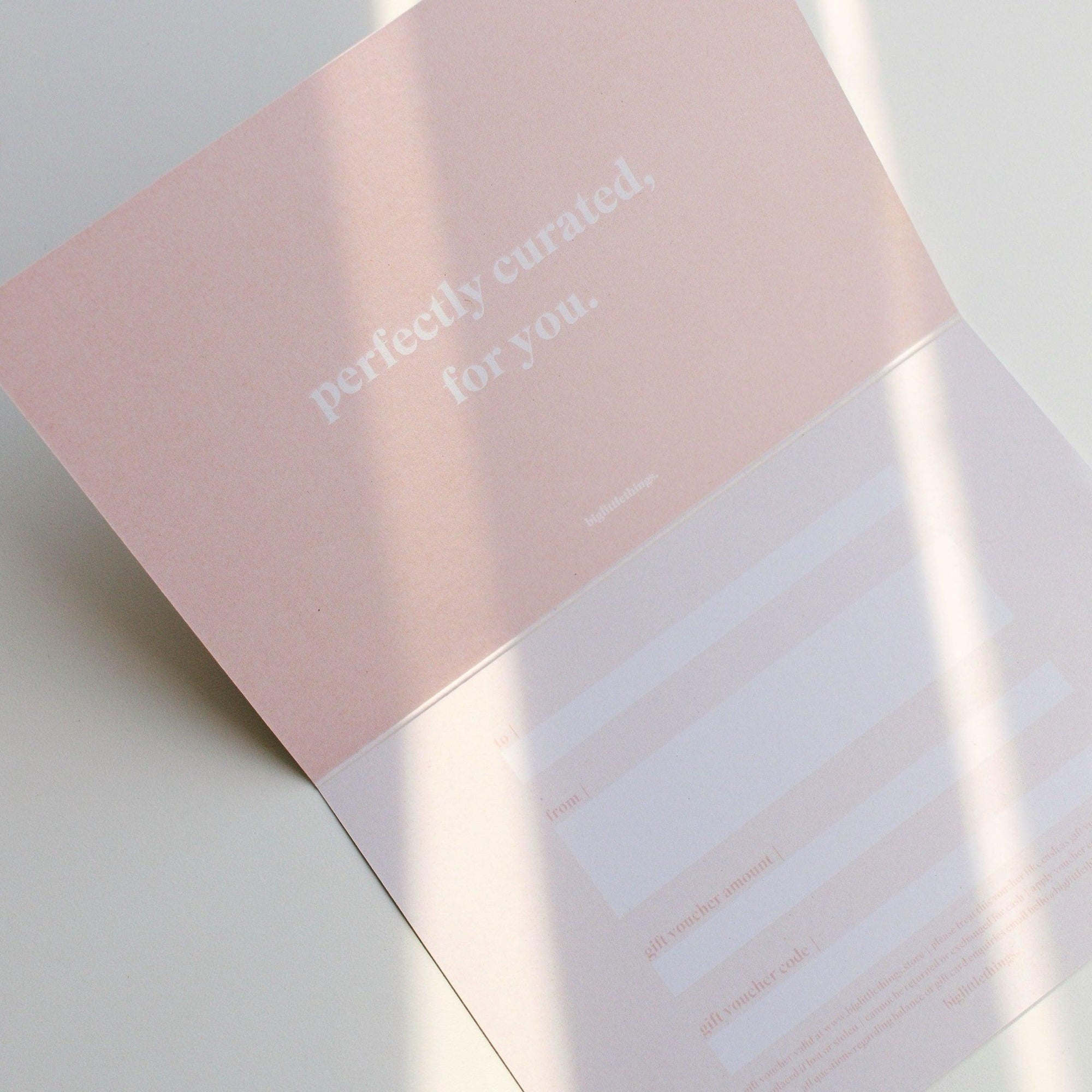 A perfectly prepared pink envelope containing a biglittlethings gift voucher.