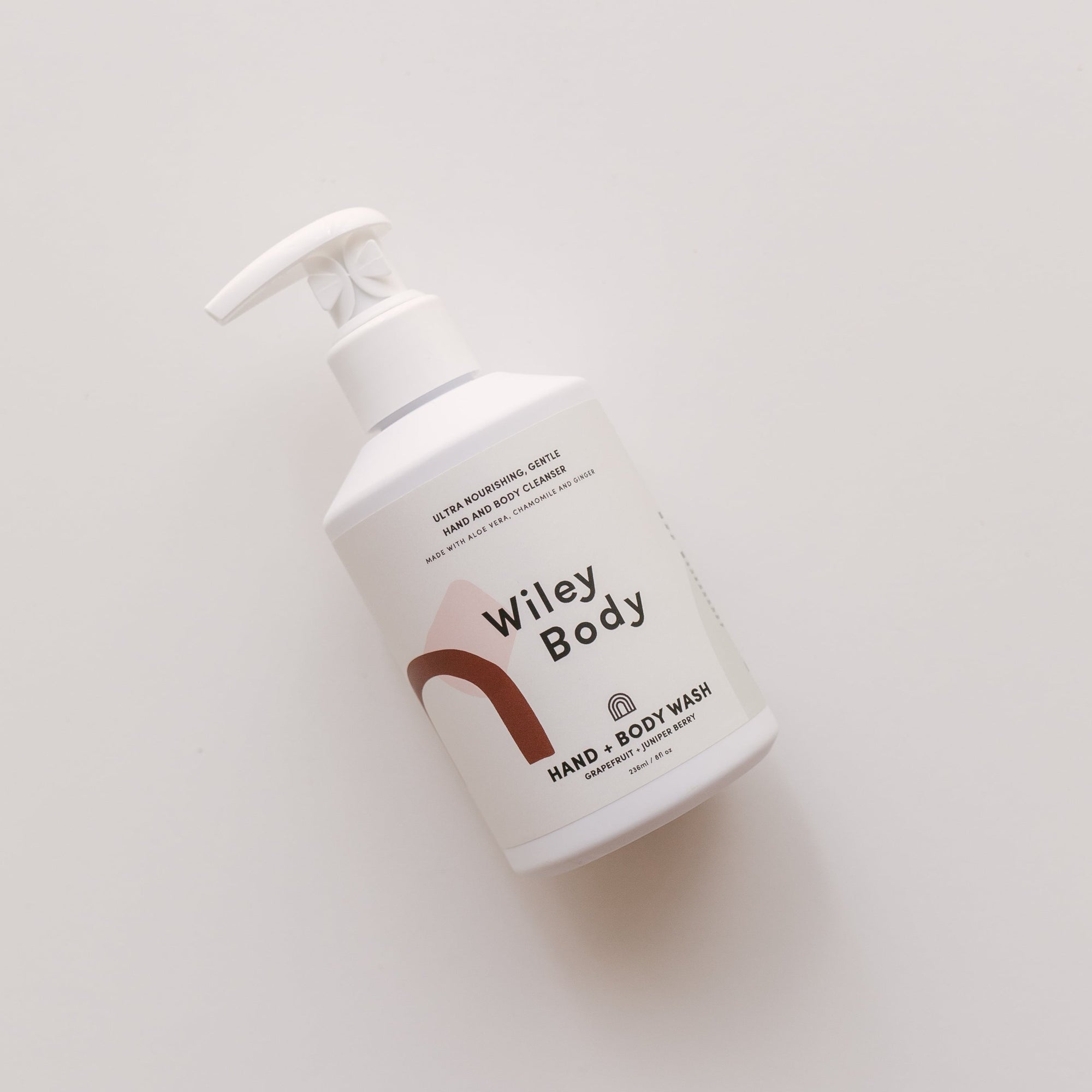 A Wiley Body hand & body wash featuring the superfood ginger, placed on a white surface.