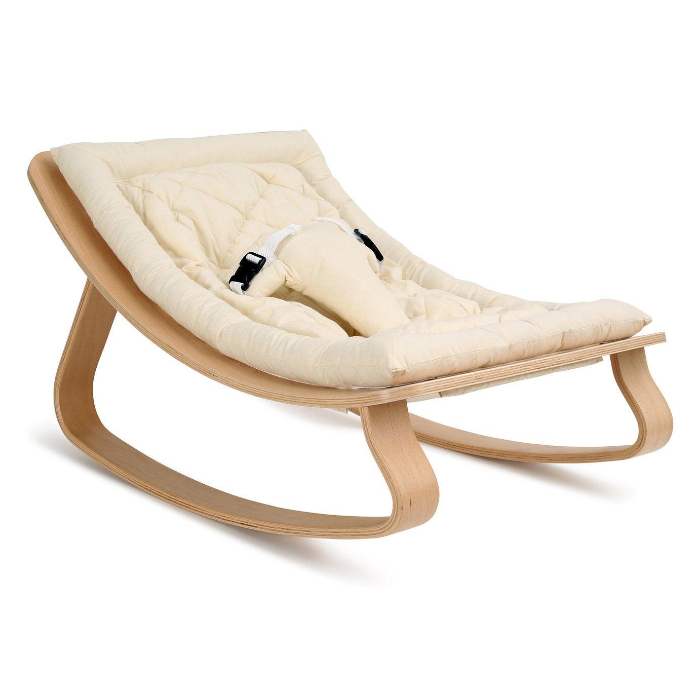 A wooden Levo baby rocker by Charlie Crane with a white background.