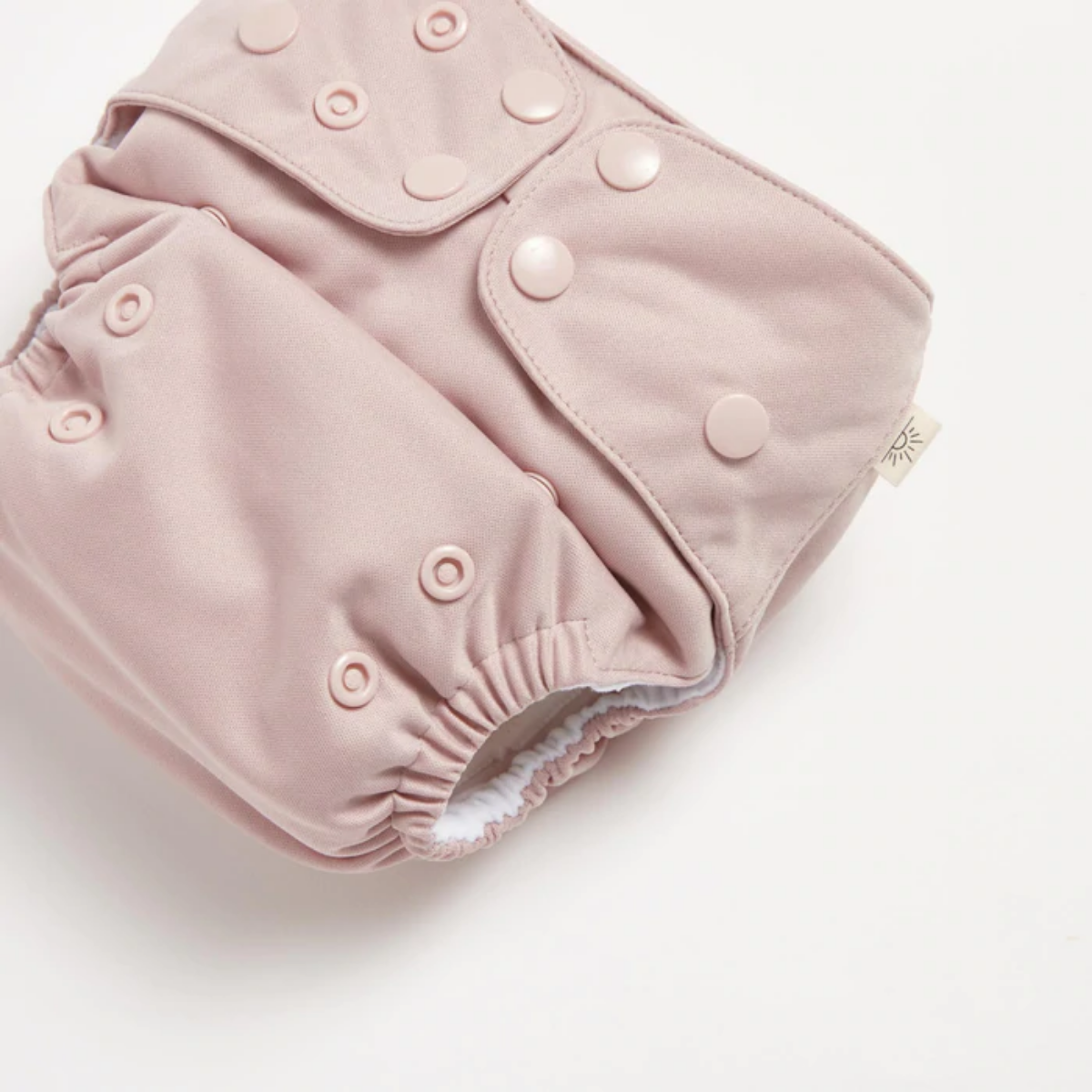 A close up of Dusty Rose 2.0 Modern Cloth Nappy by EcoNaps on a white surface.
