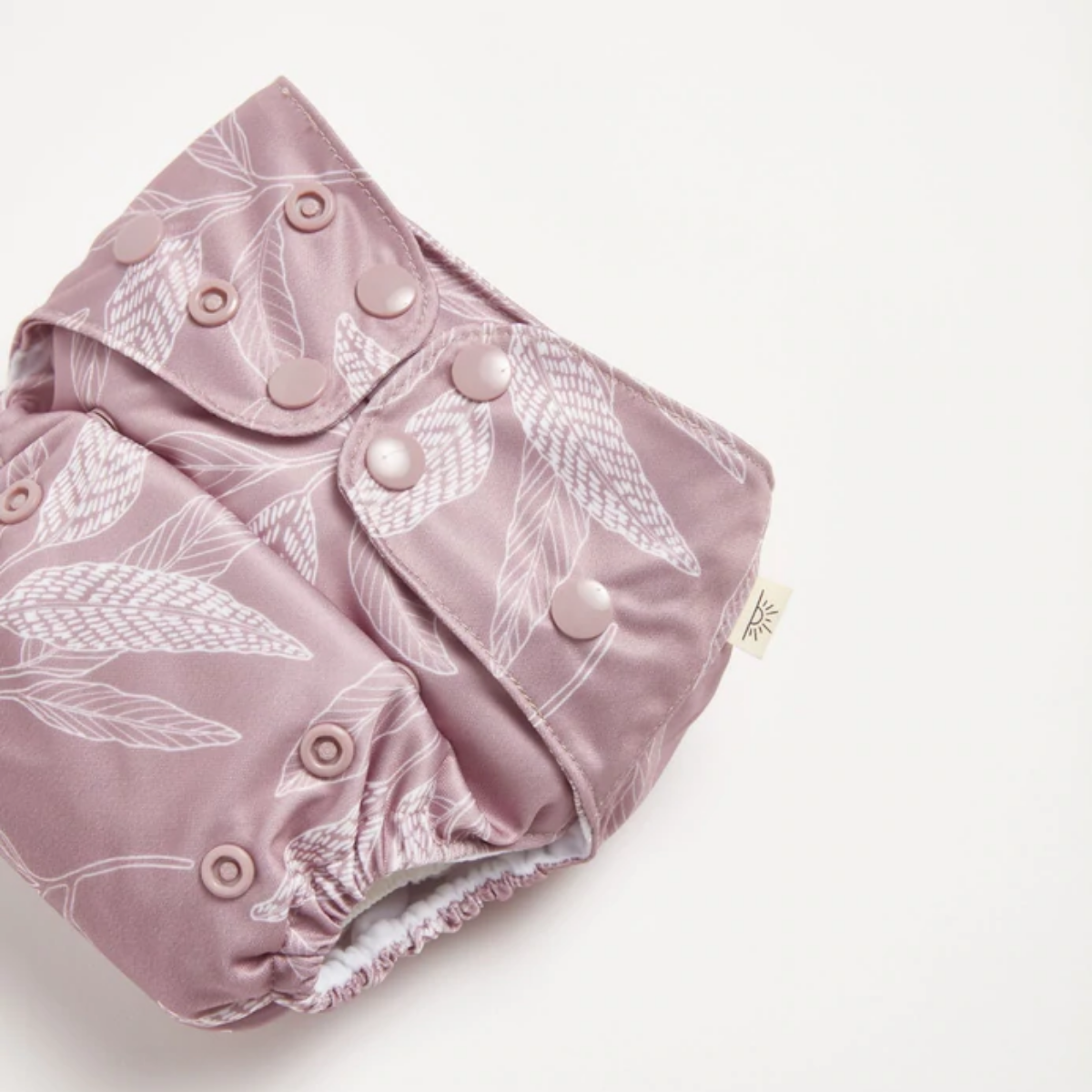 A modern cloth nappy with a native print from EcoNaps in the shade Mauve Native 2.0 on a white background.