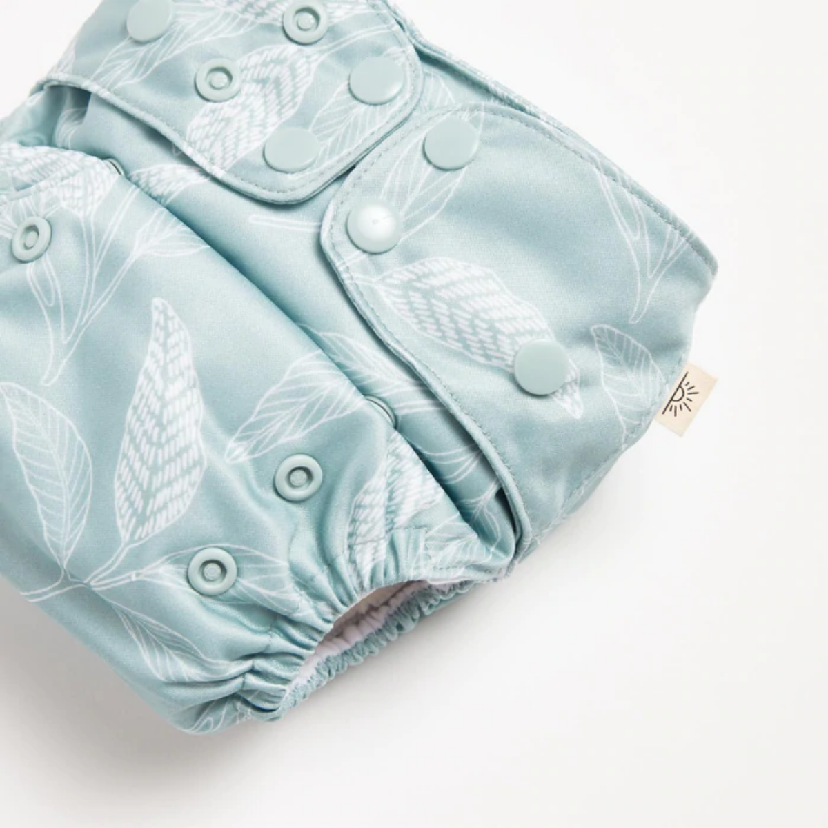 A close up of Ocean Native 2.0 Modern Cloth Nappy with white native prints on it by EcoNaps.