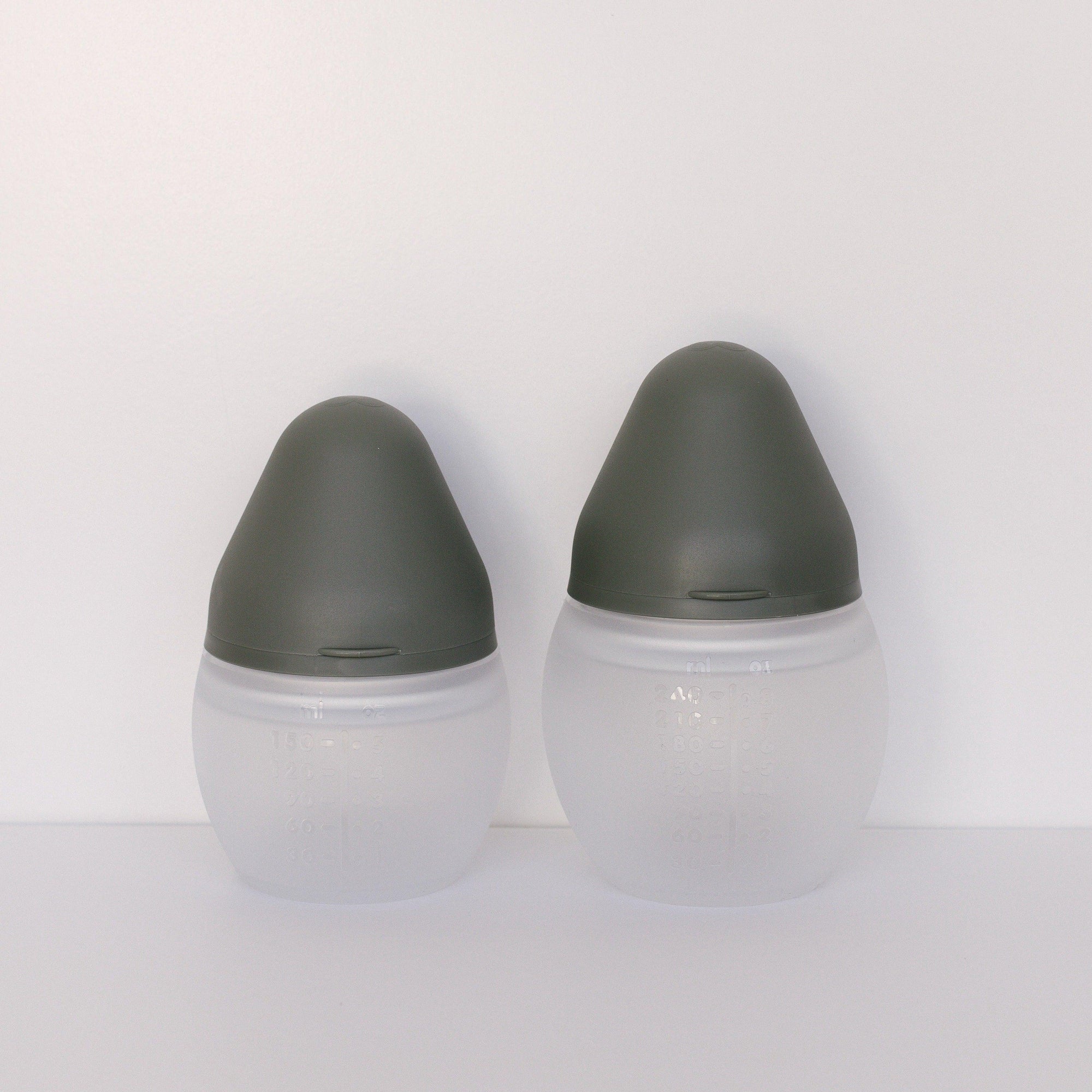 Two BibRond khaki bottles from Elhée France standing on a white surface.