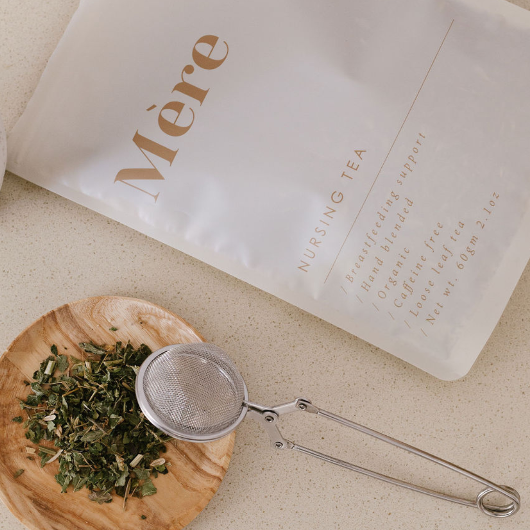A bag of Mère Nursing Tea next to a spoon on a table.