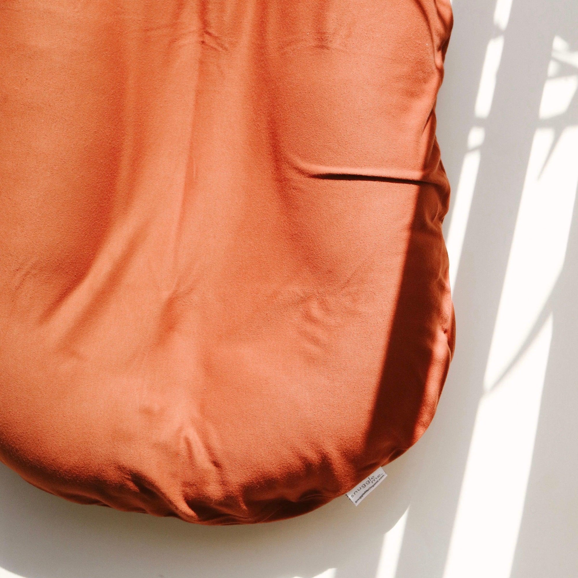 The Snuggle Me Lounger Cover in the shade Gingerbread on a white surface.